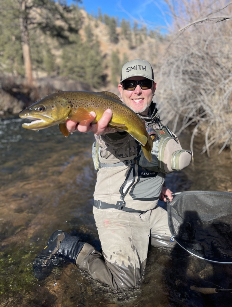 Chris Smith with a brown trout in Colorado