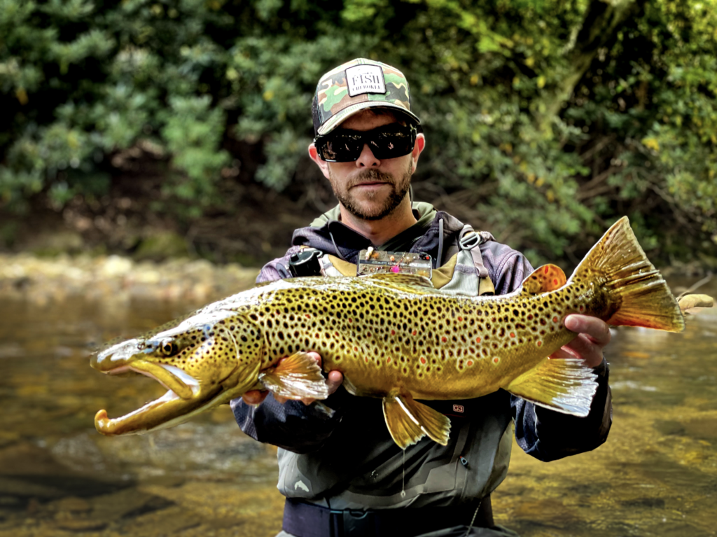 Austin Shoemaker with a large brown trout
